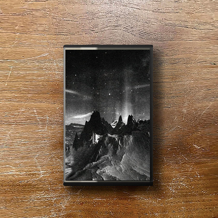 Framed black and white mountain landscape on a wooden surface