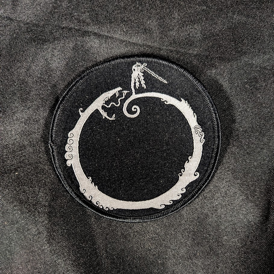 Woven patch, black background, white detail