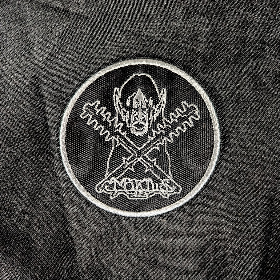 Woven patch, black background, white detail
