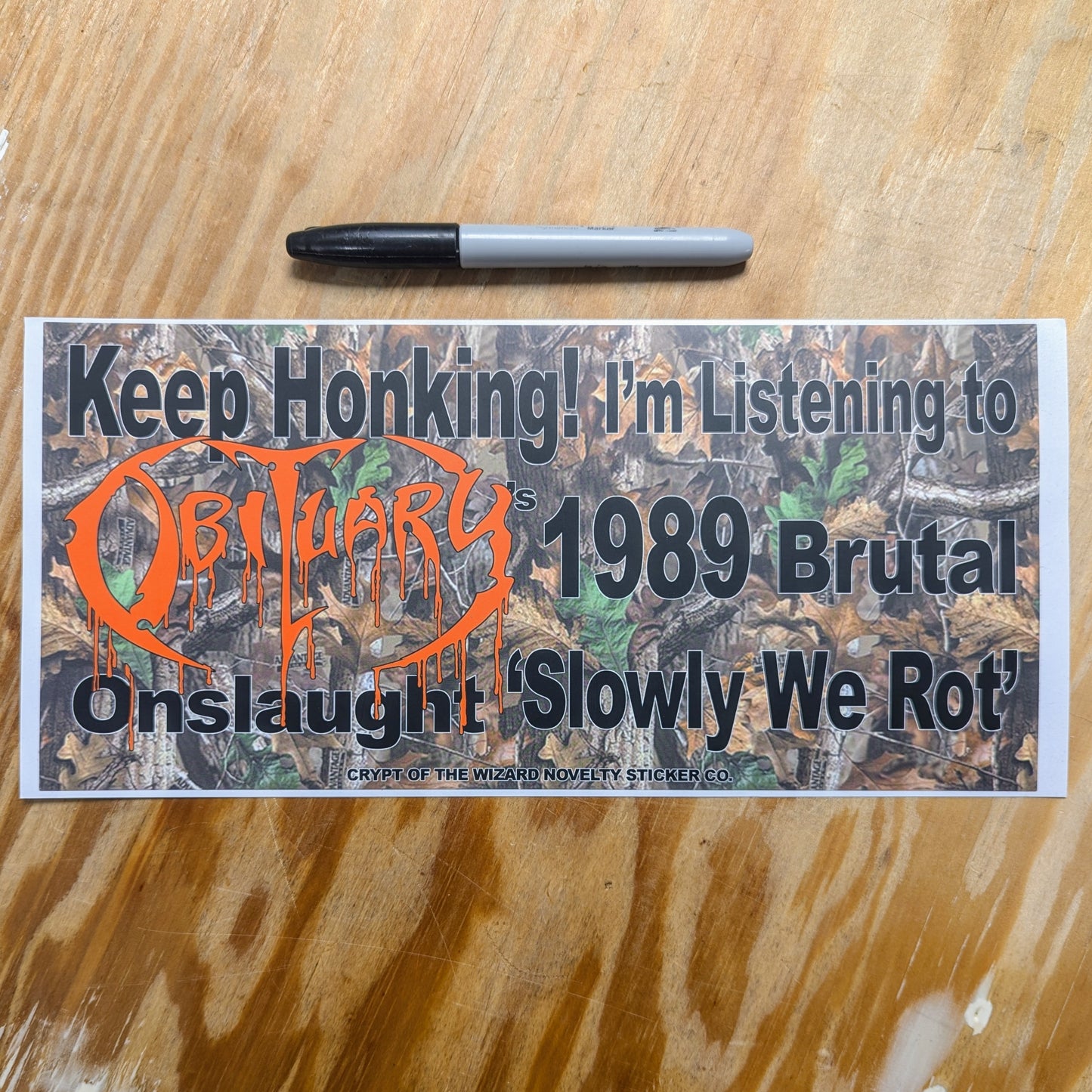 Keep Honking "OBITUARY" 12"x5" Bumper Sticker with text "Keep Honking! I'm Listening to Obituary's 2989 Brutal Onslaught 'Slowly We Rot', next to a Sharpie marker for size comparison