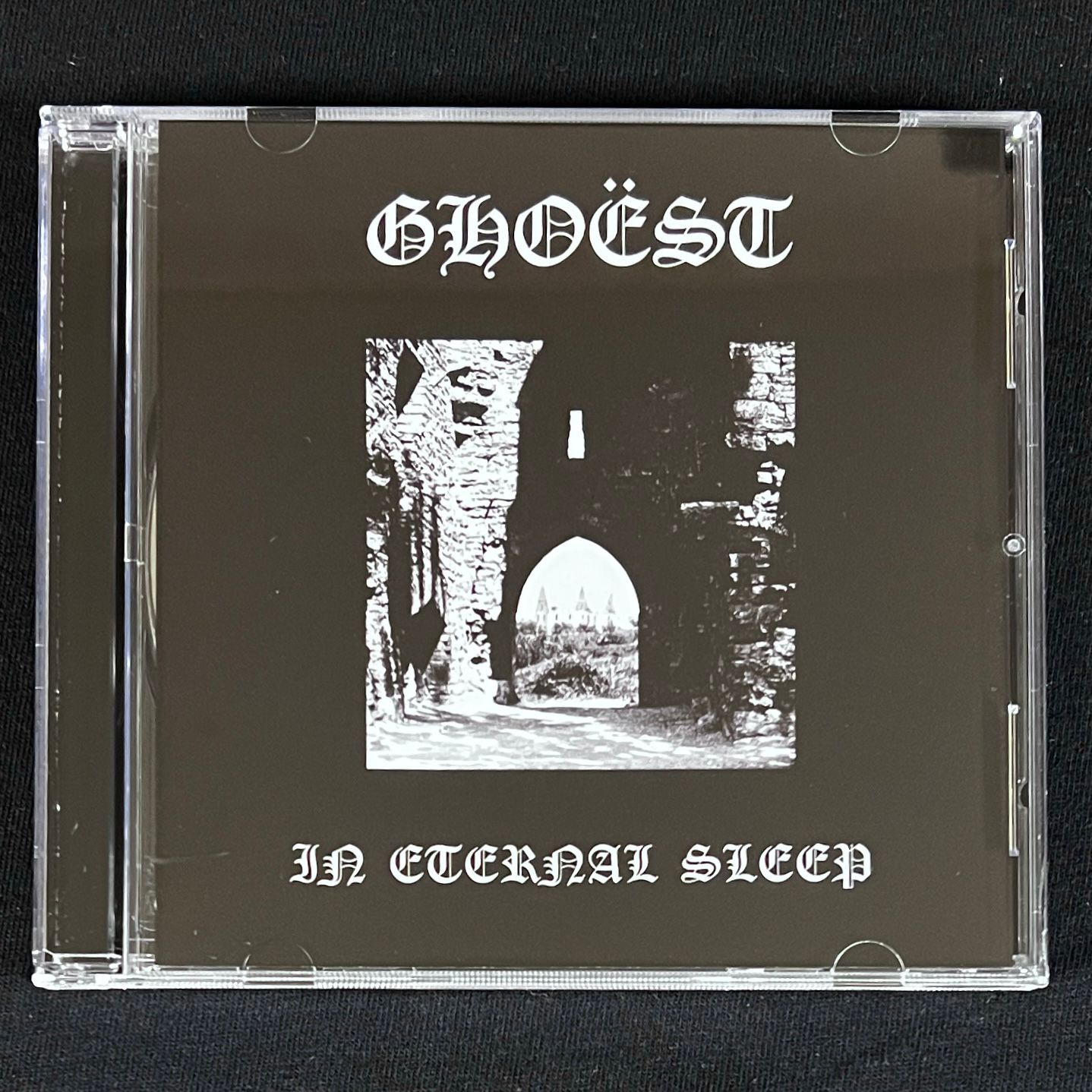 CD case with 'GHOEST' and 'In Eternal Sleep' text on a black background