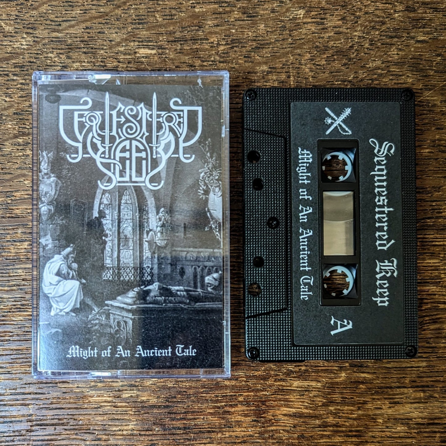 SEQUESTERED KEEP "Might of an Ancient Tale" cassette tape, black shell with printed sticker label, norelco case and printed j-card