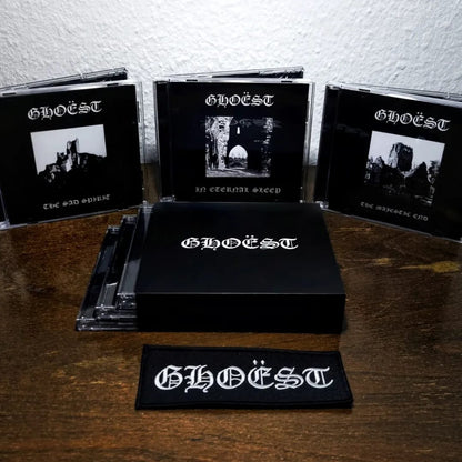 Collection of 'GHOEST' music albums and merchandise on a wooden surface.