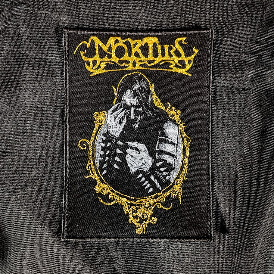 Woven patch, black background, gold detail