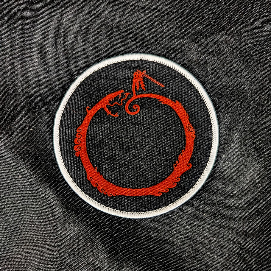 Woven patch, black background, red and white detail