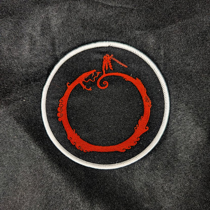 Woven patch, black background, red and white detail