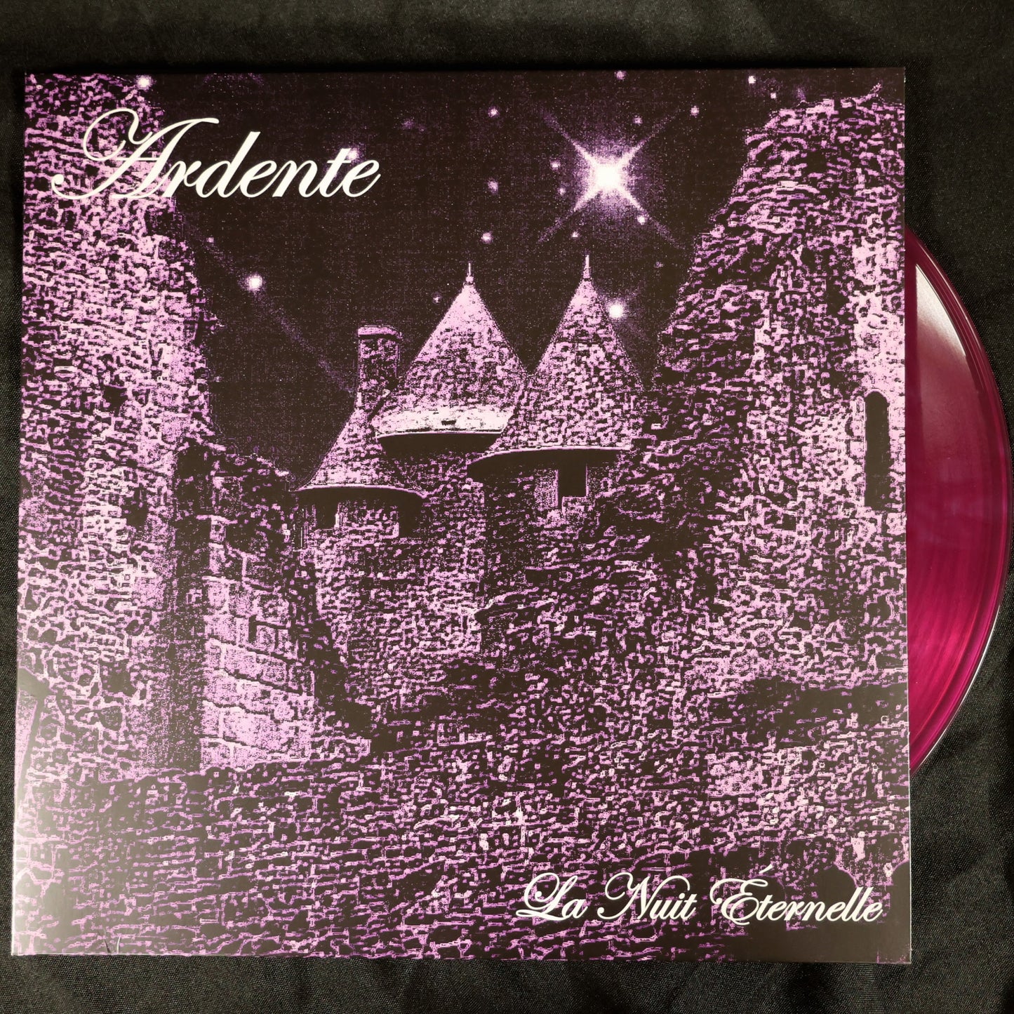 Vinyl record with a castle design and 'Ardente' text on a black background