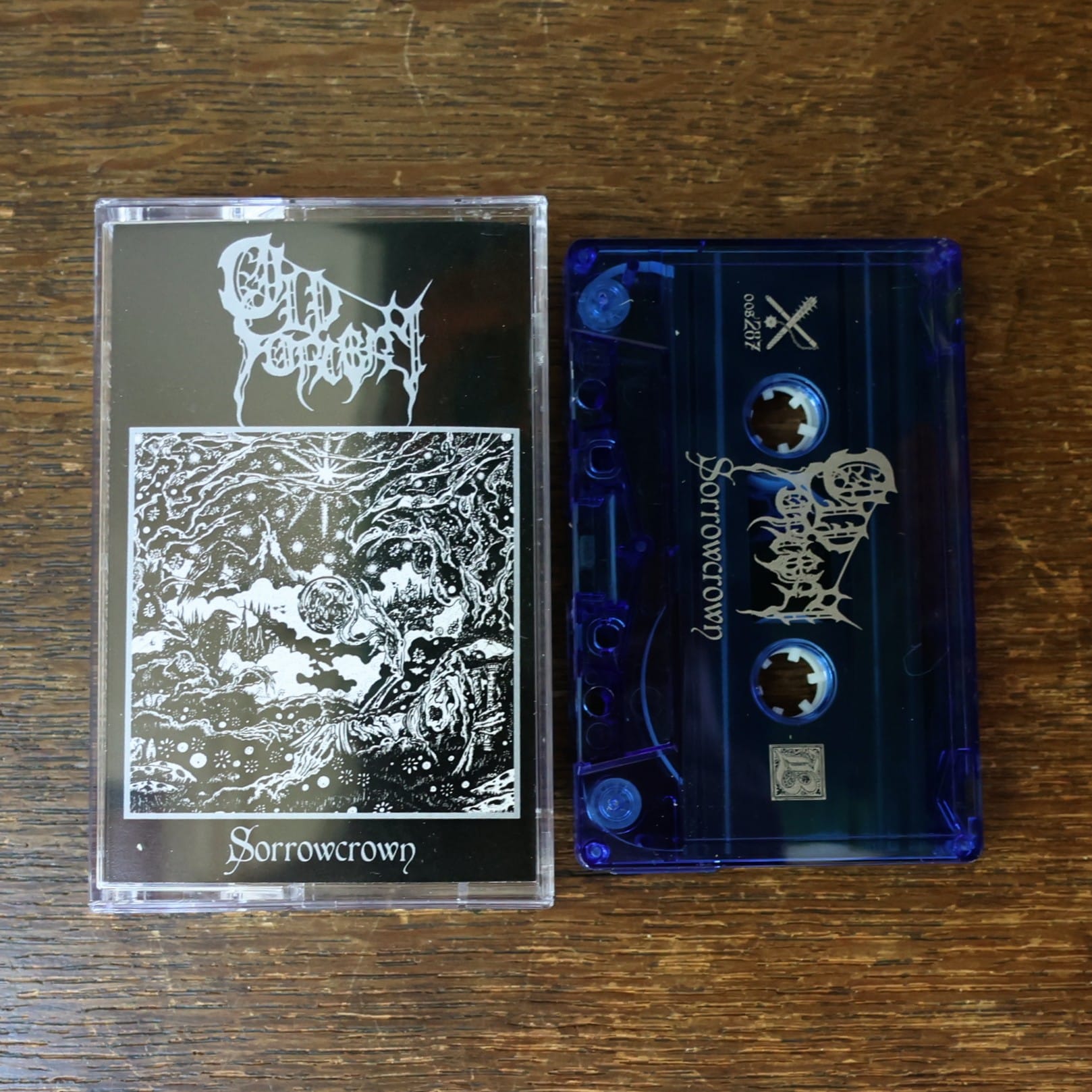 Cassette tape with 'Sorrowcrown' on a wooden surface