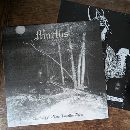 Album cover with text 'Mortiis' and 'Forgotten' on a wooden surface