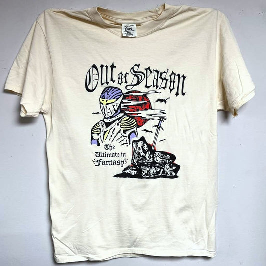 Beige t-shirt with graphic design and text 'Out of Season' on a gray background