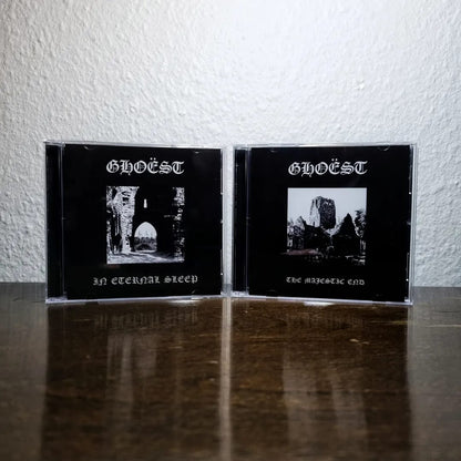 Two black CDs with 'GHOEST' on the cover, featuring black and white images, on a reflective surface.