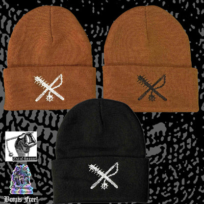 Three beanies in brown, black, and black with embroidered designs on a patterned background.