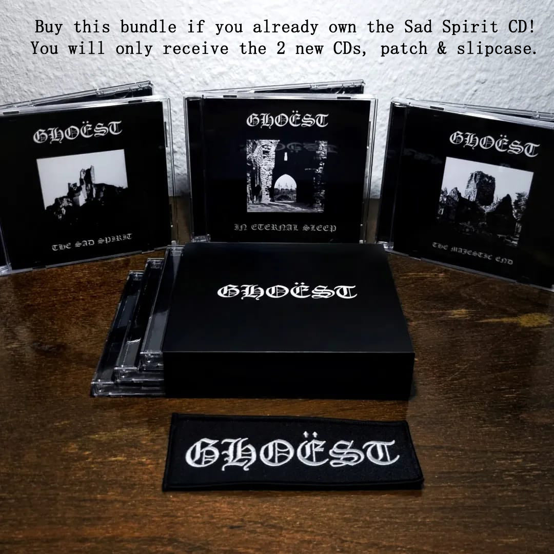 GHOEST music bundle with CDs, patch, and slipcase on a wooden surface.