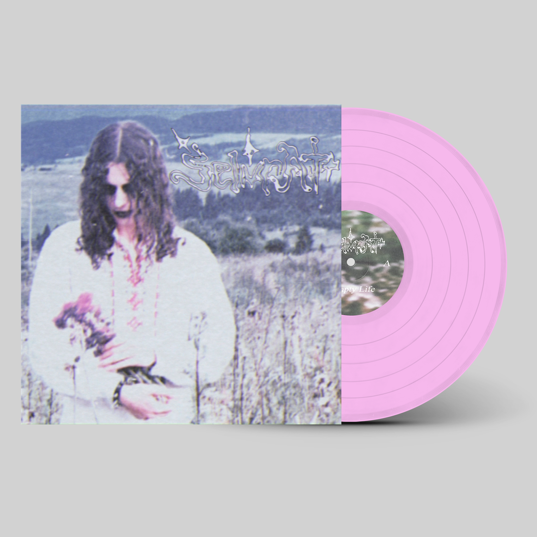 Vinyl record with a pink disc and cover featuring a person with long hair on a gray background