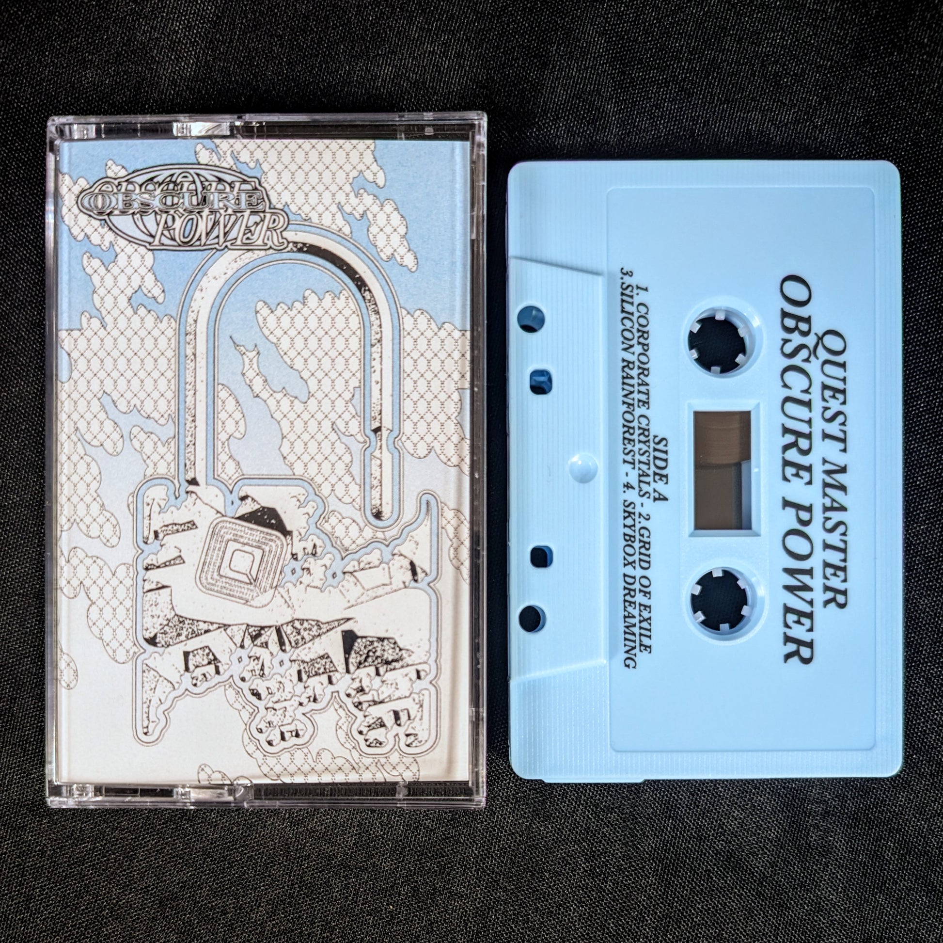 Cassette tape with 'Quest Master Obscure Power' design on a black background