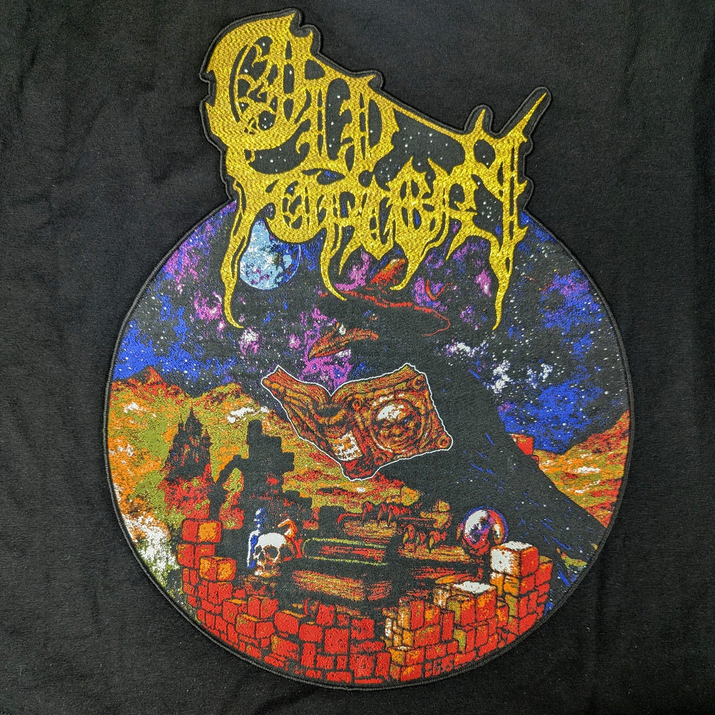 Decorative patch with intricate design and text on a black background