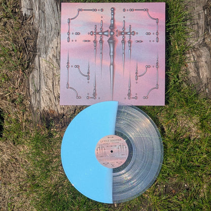 Vinyl record with a colorful cover on grass
