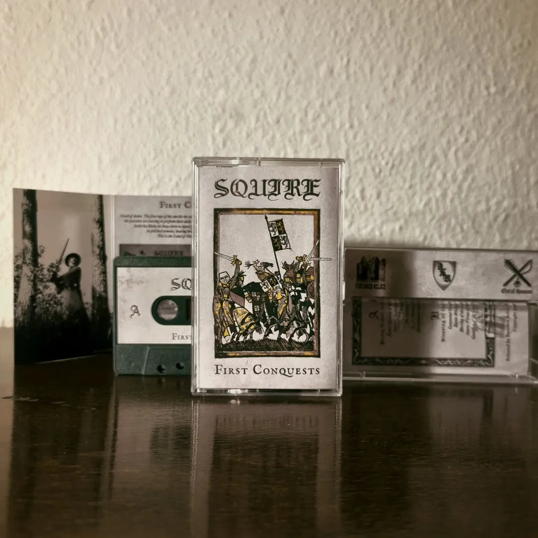Squire 'First Conquests' cassette tape with cover and inner sleeve on a wooden surface.