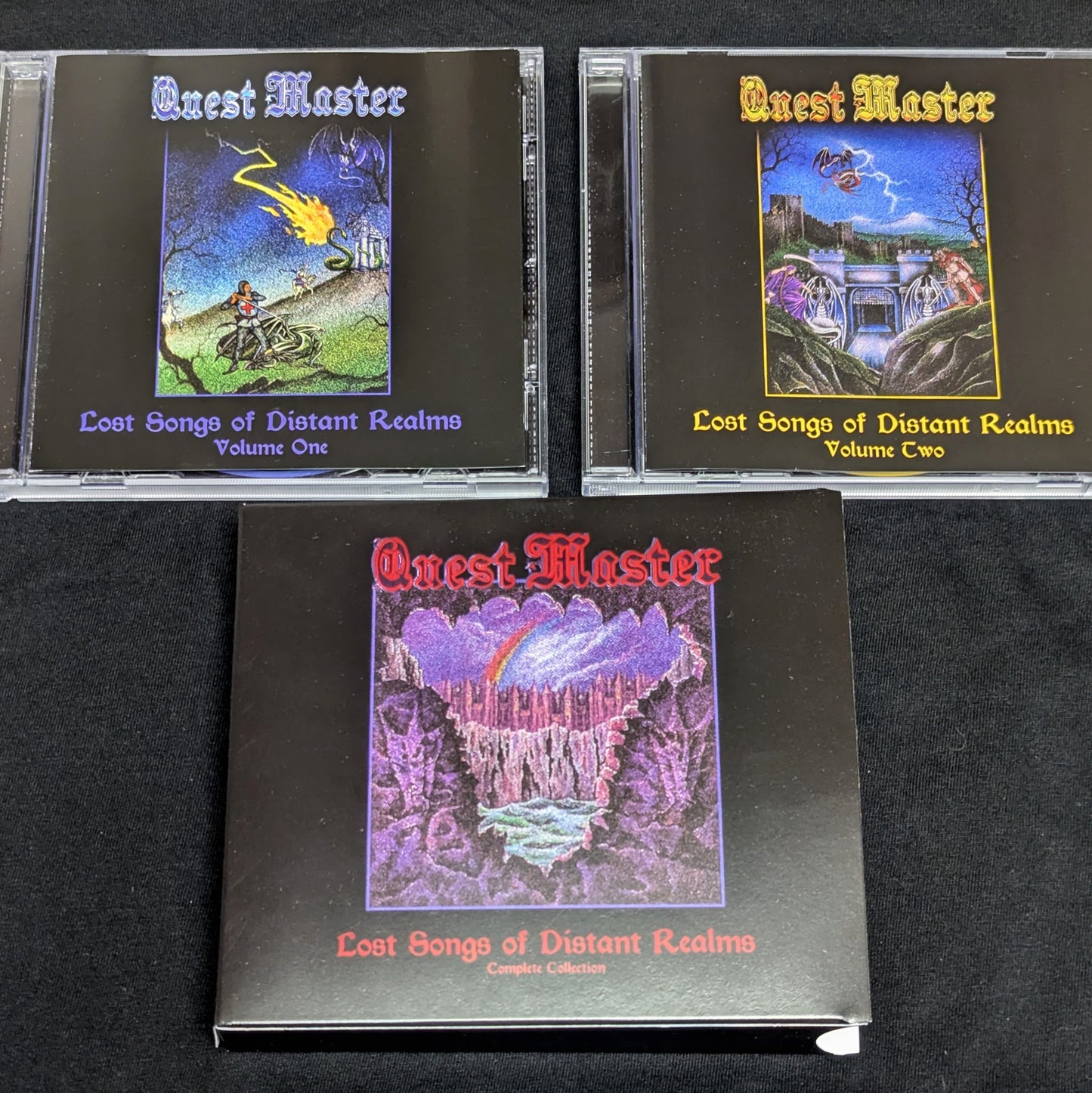 'Quest Master' music albums on a black surface