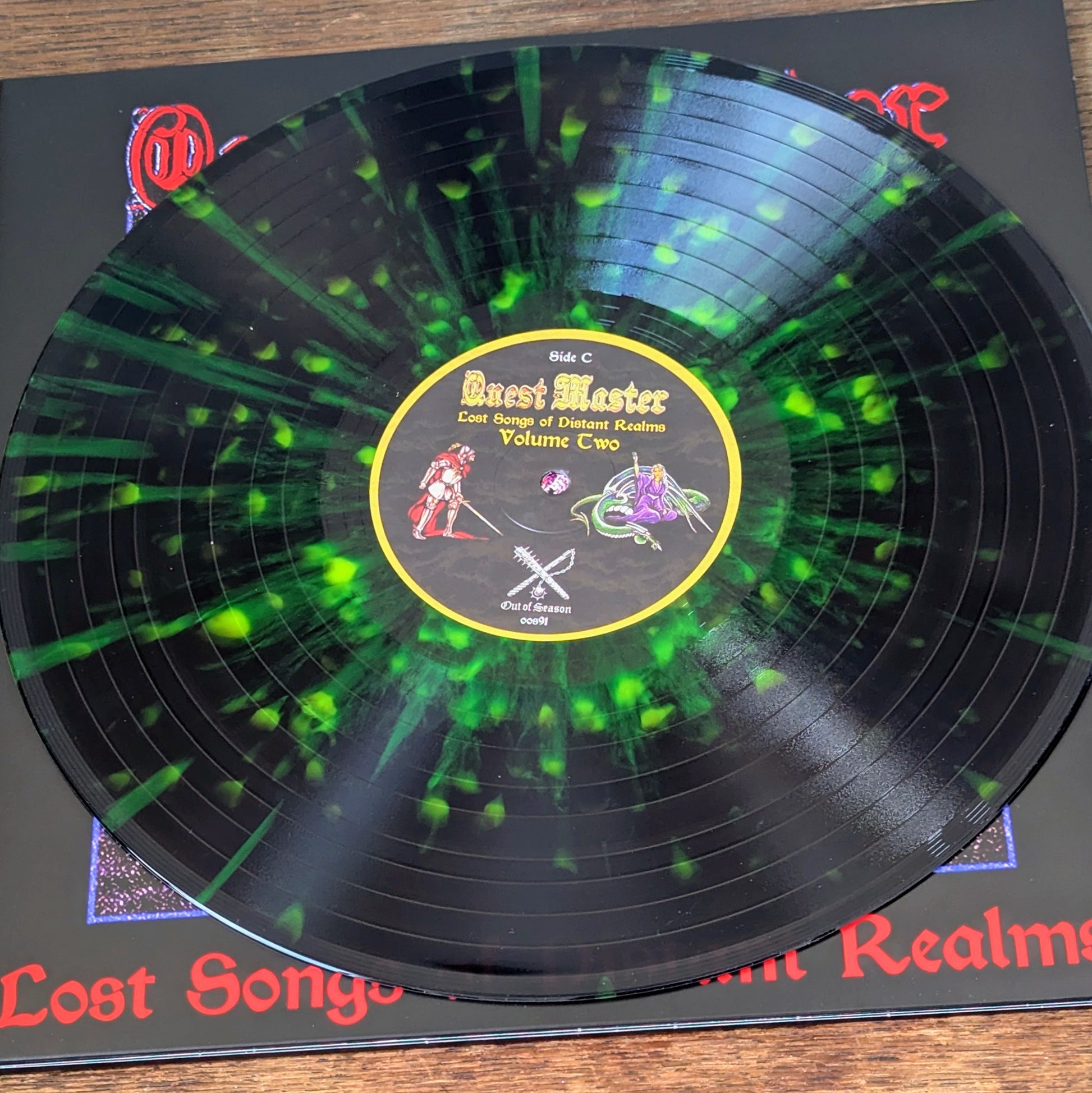 Vinyl record with a green and black design on a wooden surface