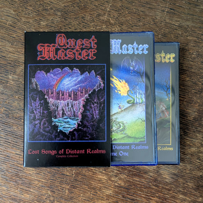 Three 'Quest Master' books on a wooden surface